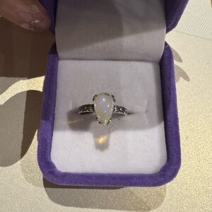 White opal stone on 925 silver setting

Adjustable